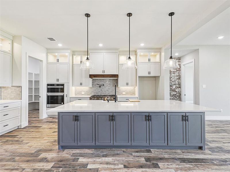 Gleaming Quarts countertops, contemporary appliances, and ample cabinet space converge to create a culinary haven!