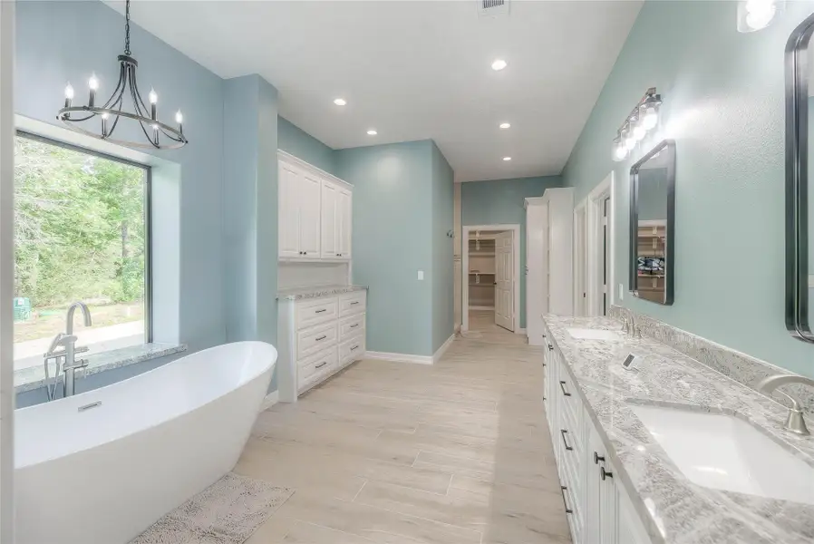 Primary bathroom with a walk-in closet and a double sink. Also has a separate tub/shower combo and plenty of cabinet and counter space Primary bathroom with a walk-in closet and a double sink. Also has a separate tub/shower combo and plenty of cabinet and counter space
