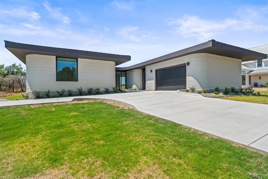 Front exterior of a new home in Wimberley Springs, Wimberley, TX, highlighting curb appeal (Image 1). Front exterior of a new home in Wimberley Springs, Wimberley, TX, highlighting curb appeal (Image 1).