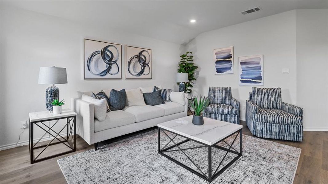 Living area with wood finished floors, recessed lighting, and vaulted ceiling Living area with wood finished floors, recessed lighting, and vaulted ceiling