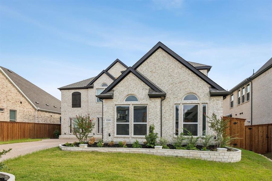 French country home with a front yard