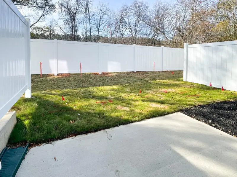 Exterior details and patio area of a home in Riverbrooke Townhomes, Simpsonville (Image 3).