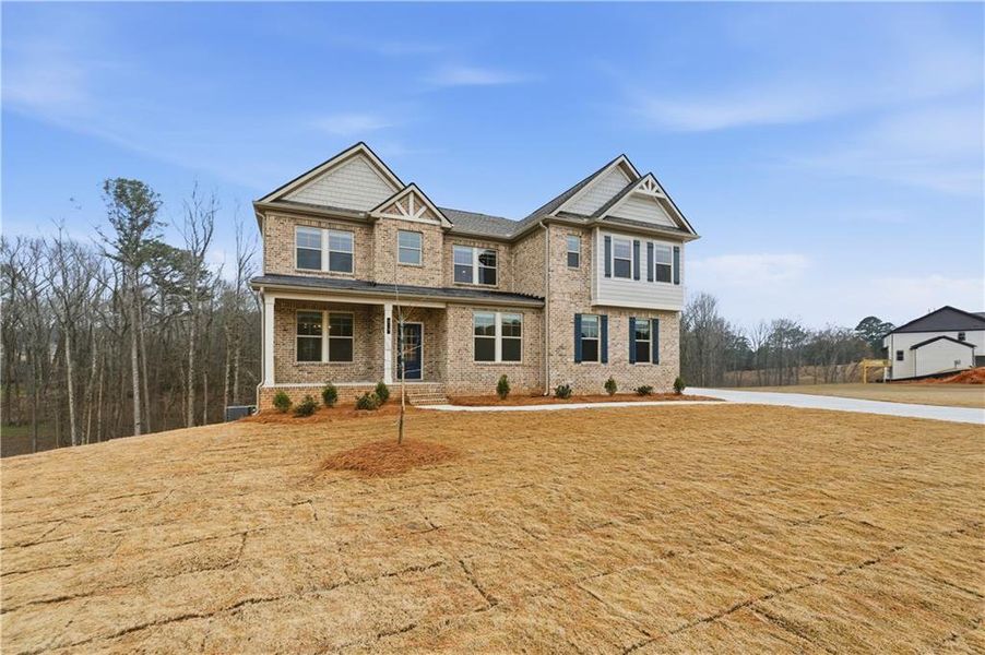 Front exterior of a new home in Trinity Park, McDonough, GA, highlighting curb appeal (Image 2). Front exterior of a new home in Trinity Park, McDonough, GA, highlighting curb appeal (Image 2).