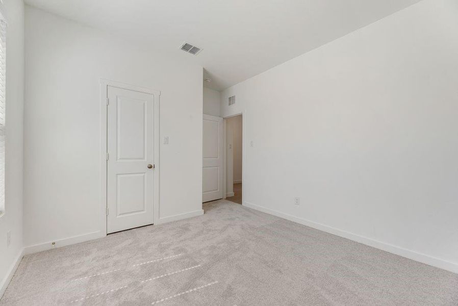 Spare room featuring carpet and baseboards Spare room featuring carpet and baseboards