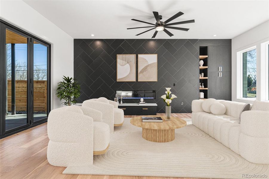 The Living Room features beautiful wide-plank hardwood floors and a cozy gas fireplace, all complemented by floor-to-ceiling tile backsplash.Virtually staged.