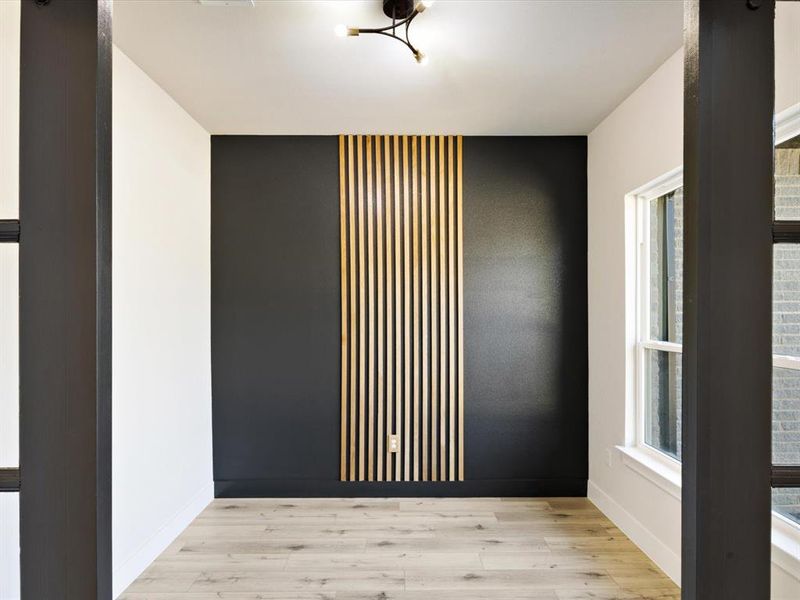 Empty room featuring wood finished floors and baseboards