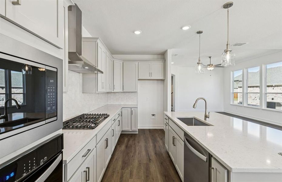 Large island overlooking gathering room and dining areas Large island overlooking gathering room and dining areas