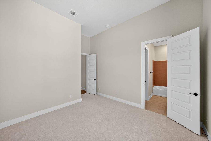 Unfurnished bedroom featuring light colored carpet and baseboards Unfurnished bedroom featuring light colored carpet and baseboards