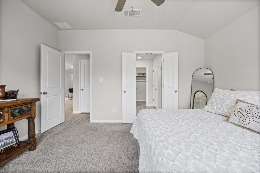 Soft plush carpeting pairs with neutral walls in this comfortable bedroom space.