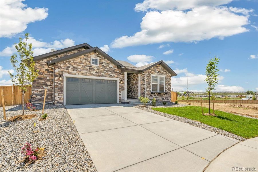 Front exterior of a new home in Windsong, Thornton, CO, highlighting curb appeal (Image 21).
