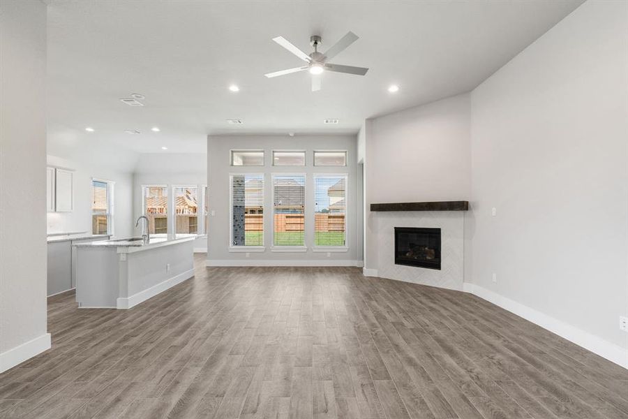 Take another glimpse into the heart of the home with this additional view of the family room—a sprawling space ready to accommodate all your gatherings. Sample photo of completed home with similar floor plan. As-built interior colors and selections may vary.