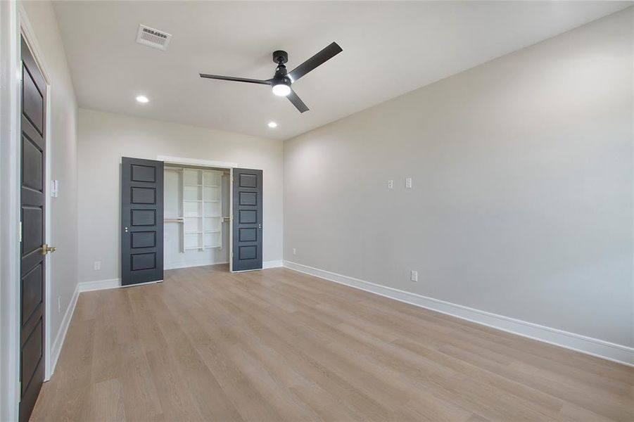 Unfurnished bedroom featuring ceiling fan, a closet, and light hardwood / wood-style floors