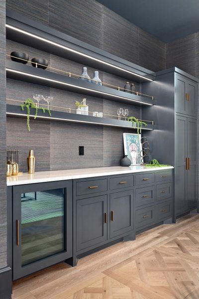 Custom cabinetry and elegant floating shelves illuminate this chic entertaining space.