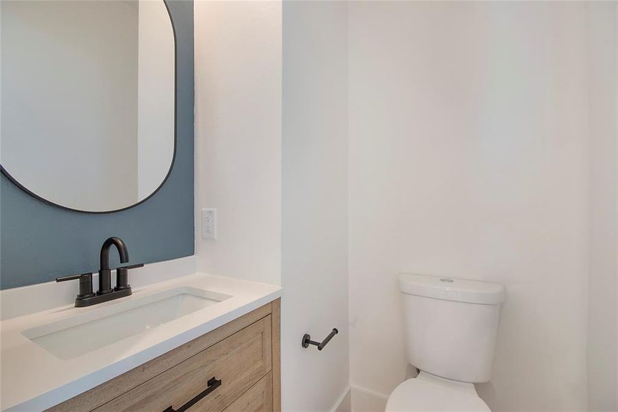 Half bath with vanity and toilet Half bath with vanity and toilet
