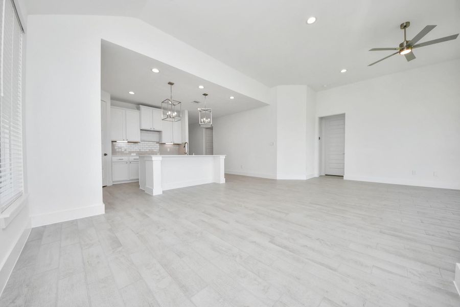 Discover another perspective of this stunning kitchen, generously appointed with an abundance of counter space