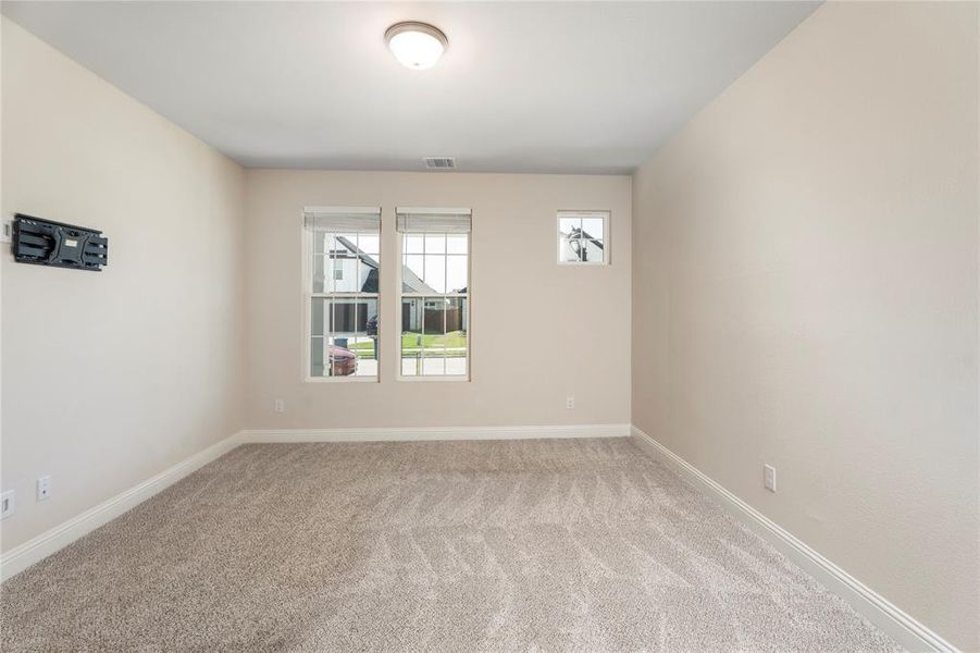 Carpeted empty room featuring baseboards