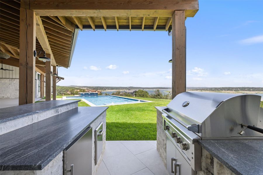 View of patio / terrace featuring an outdoor pool and an outdoor kitchen