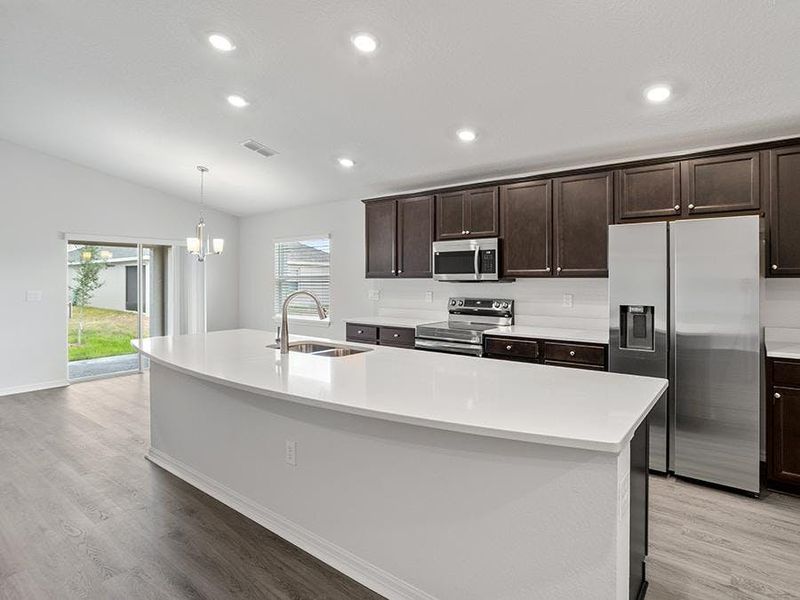Your bright and open kitchen features a large island, with ample cabinet and counter space - Remy by Highland Homes Your bright and open kitchen features a large island, with ample cabinet and counter space - Remy by Highland Homes