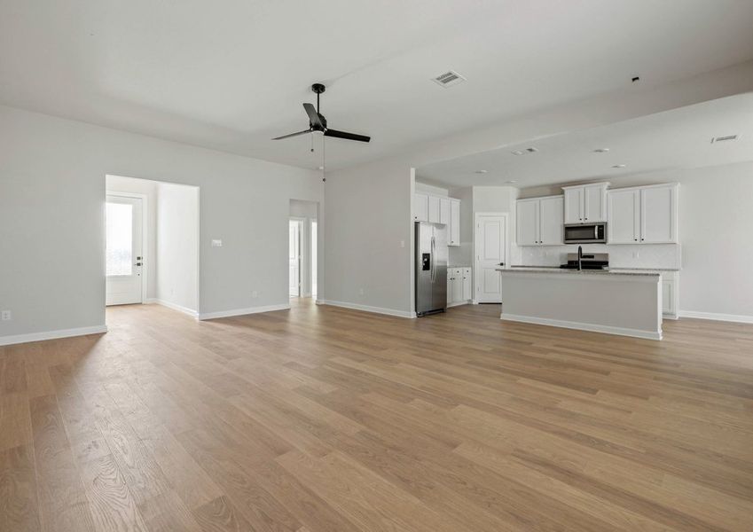 Famiy room with a large window. The dining room and kitchen are also seen in the back. Famiy room with a large window. The dining room and kitchen are also seen in the back.