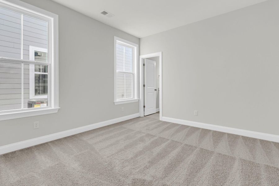 Spacious, unfurnished interior of a new home in Tidewater at Lakes of Cane Bay, Summerville (Image 34).