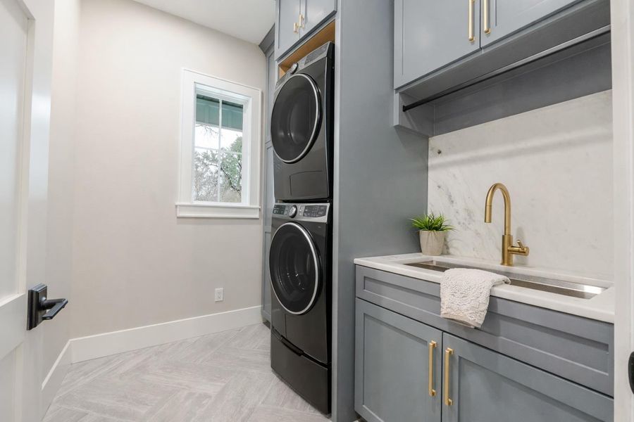 Laundry room with cabinet space and stacked washer and clothes dryer