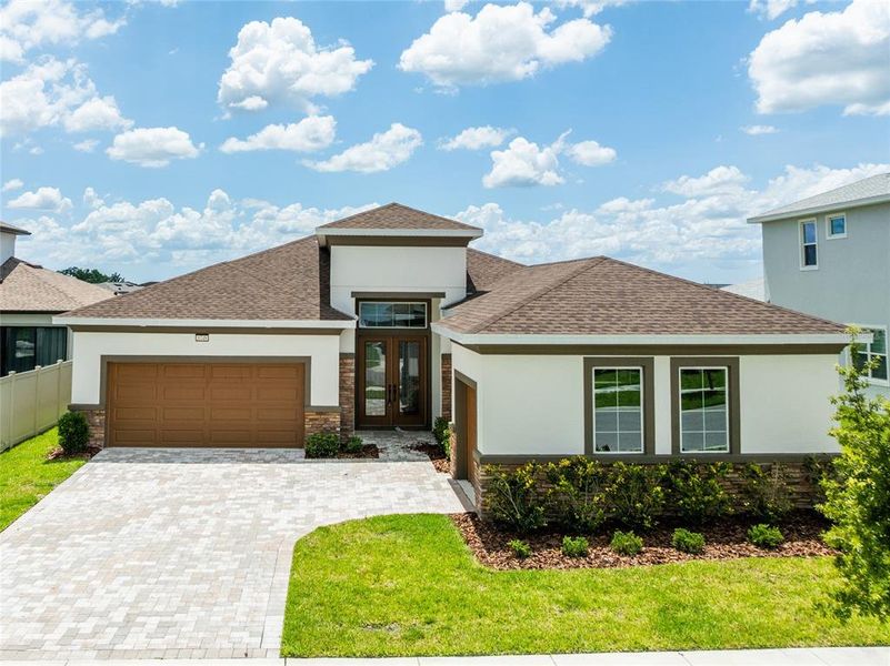 Front exterior of a new home in , Wesley Chapel, FL, highlighting curb appeal (Image 1).