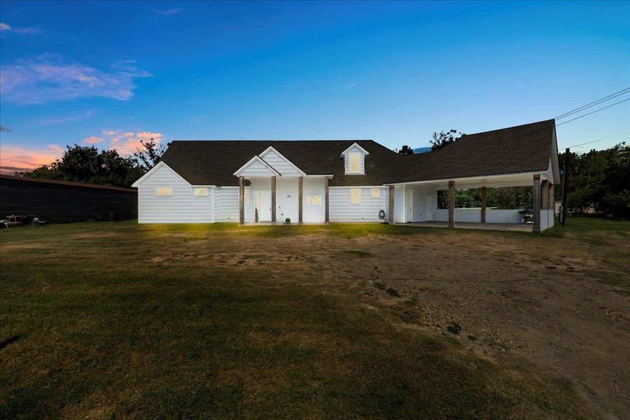 Modern inspired farmhouse featuring a front yard and roof with shingles Modern inspired farmhouse featuring a front yard and roof with shingles
