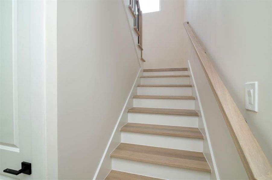 Stairway with hardwood / wood-style floors