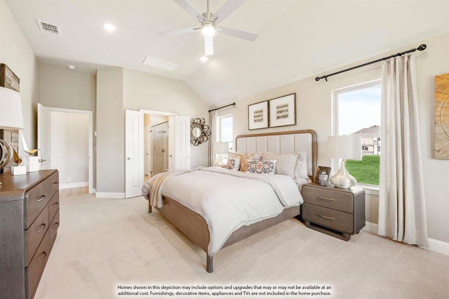 Master bedroom with vaulted ceiling, ceiling fan, carpet floors, and ensuite bathroom door visible
