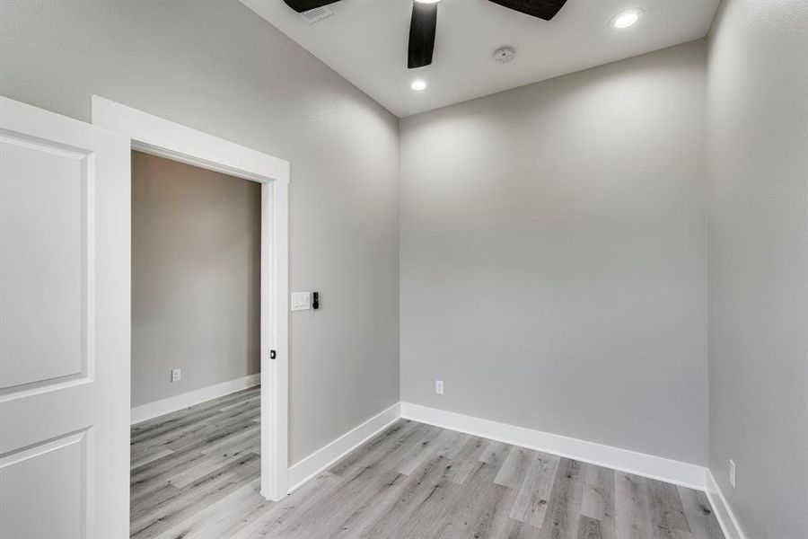 Unfurnished room featuring light wood-type flooring and ceiling fan