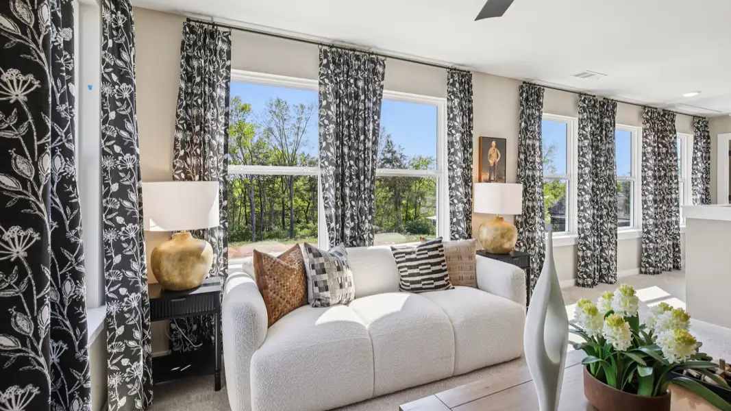 Loft area surrounded by large windows, allowing for tons of natural light in the home