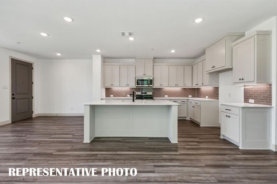 Your new kitchen features a spacious island perfect for a quick bite or homework station!  REPRESENTATIVE PHOTO