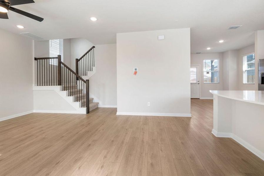 Unfurnished living room featuring a ceiling fan, recessed lighting, and light wood-style flooring
