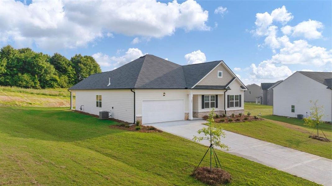 Front exterior of a new home in Bridle Creek, Locust Grove, GA, highlighting curb appeal (Image 18).