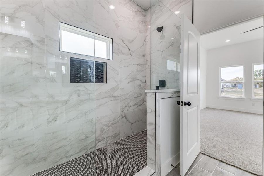 Bathroom featuring a tile shower