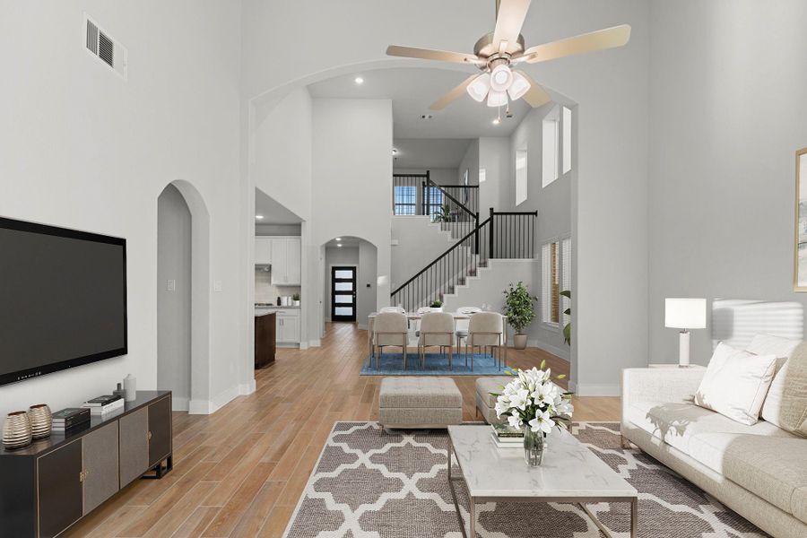 Another view highlights the home’s stunning architecture, with a dramatic two-story ceiling and an elegant staircase that enhances the open and airy layout. *Staged Photo* Another view highlights the home’s stunning architecture, with a dramatic two-story ceiling and an elegant staircase that enhances the open and airy layout. *Staged Photo*