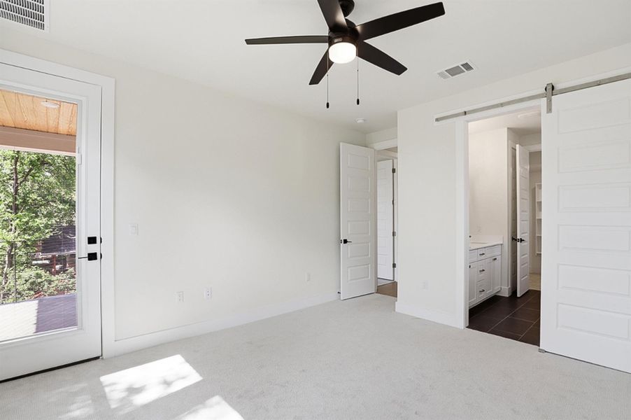 Primary bedroom, leads to balcony.