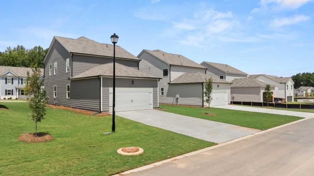 Front exterior of a new home in Braselton Village, Braselton, GA, highlighting curb appeal (Image 1). Front exterior of a new home in Braselton Village, Braselton, GA, highlighting curb appeal (Image 1).