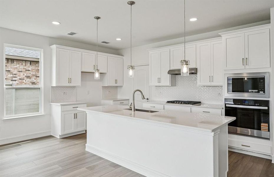 Spacious eat-in kitchen designed with a large island for dining *Real home pictured Spacious eat-in kitchen designed with a large island for dining *Real home pictured