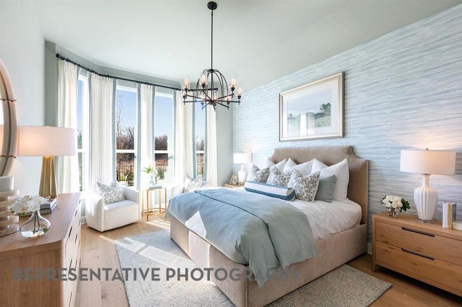 Bedroom with light wood-type flooring and a chandelier