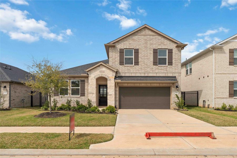 Front exterior of a new home in Sunterra, Katy, TX, highlighting curb appeal (Image 26). Front exterior of a new home in Sunterra, Katy, TX, highlighting curb appeal (Image 26).