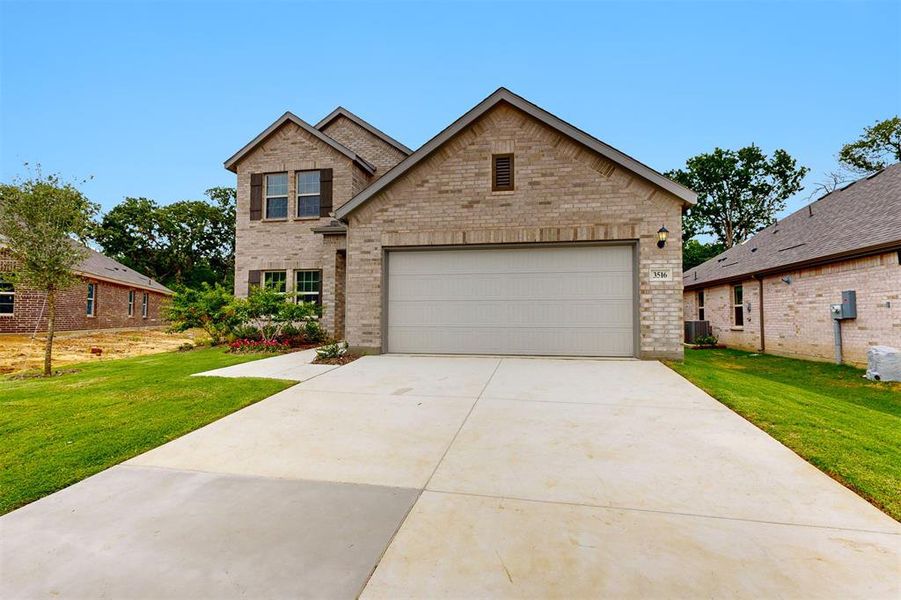 Front exterior of a new home in Kings Way, Denton, TX, highlighting curb appeal (Image 16). Front exterior of a new home in Kings Way, Denton, TX, highlighting curb appeal (Image 16).