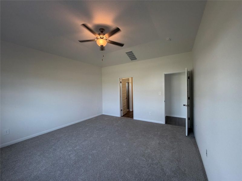 Unfurnished bedroom featuring carpet floors and a ceiling fan
