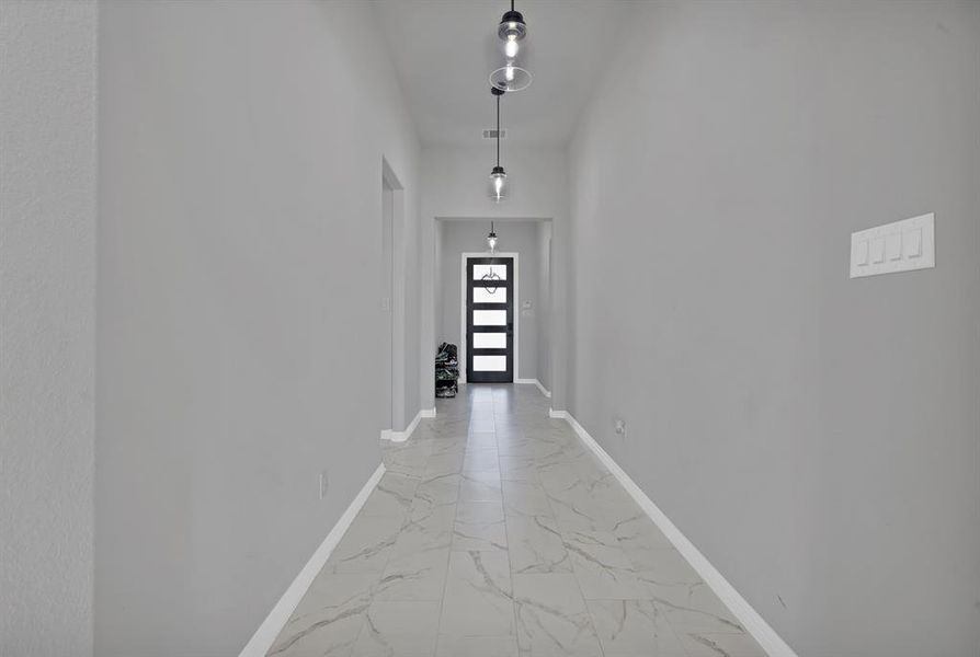 Corridor with marble finish floor and baseboards