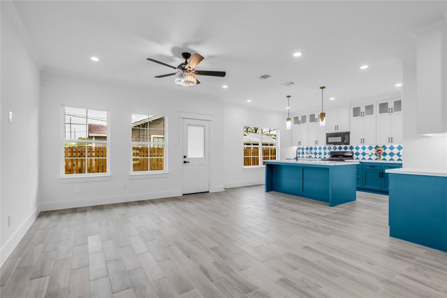 Experience open-concept living at its finest with this airy space that seamlessly combines a modern kitchen, inviting dining area, and spacious living room, perfect for entertaining and everyday comfort.