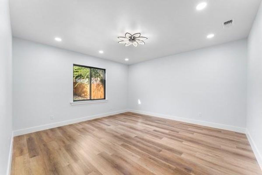 Unfurnished room featuring recessed lighting and light wood finished floors Unfurnished room featuring recessed lighting and light wood finished floors