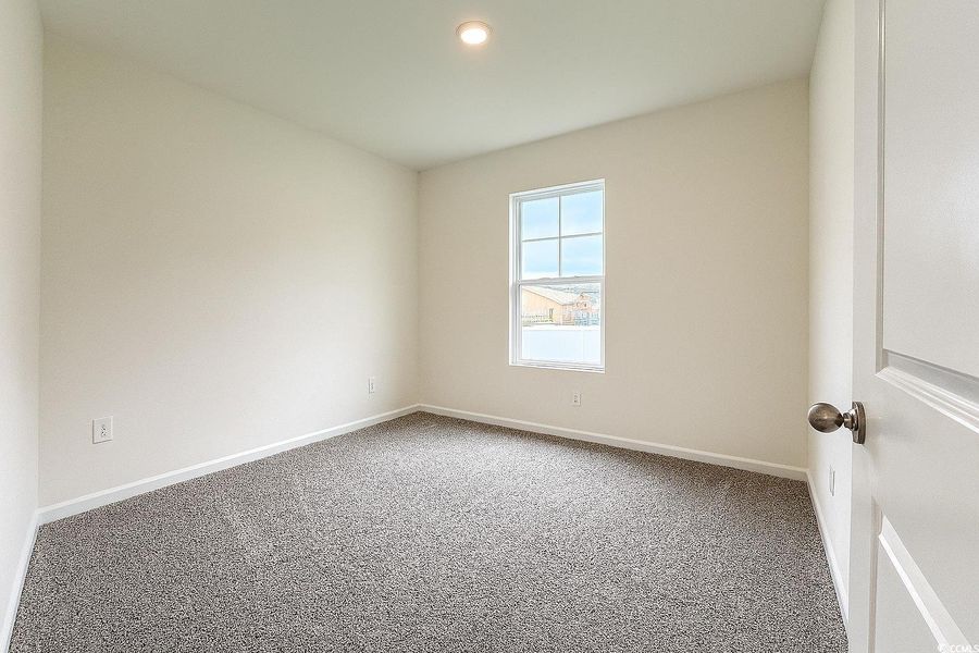 Carpeted empty room featuring baseboards and recessed lighting