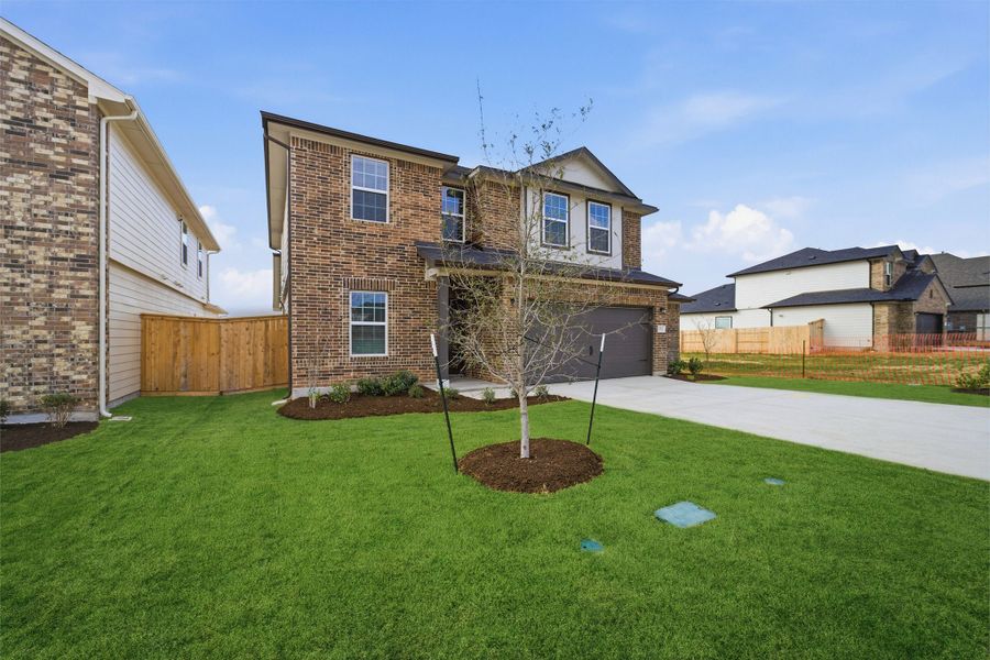 Front exterior of a new home in Briarwood, Elgin, TX, highlighting curb appeal (Image 2).