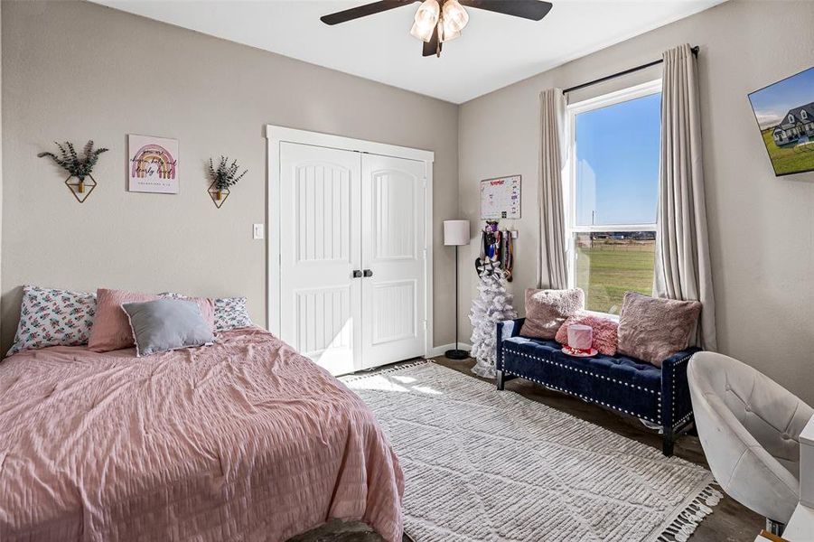 Bedroom with a ceiling fan, a closet, and wood finished floors Bedroom with a ceiling fan, a closet, and wood finished floors