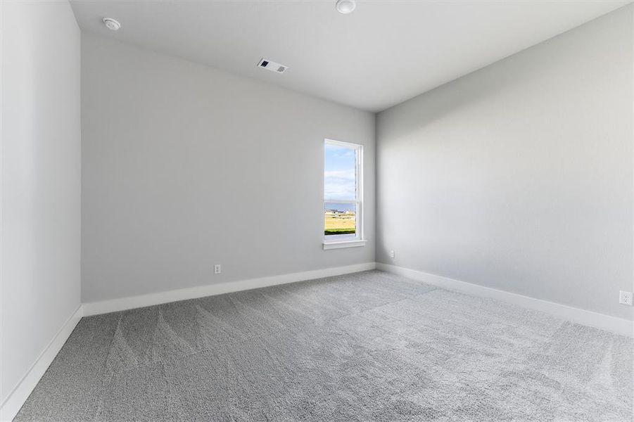 Empty room with carpet floors and baseboards